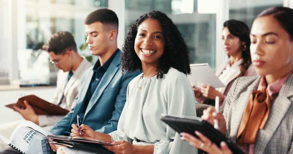 Ambitious professionals taking notes and building skills for success in entry-level jobs.